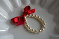 White Beaded Bracelet with Bow Design